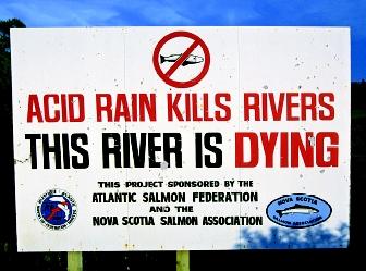A sign in Nova Scotia, Canada proclaims the potential effect of acid rain on a local river and its salmon runs. Acidified waters can be harmful or even deadly to salmon populations.