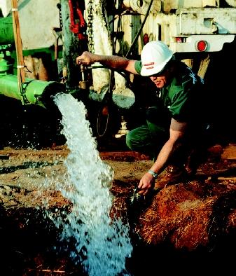 Test wells and existing wells provide valuable information about underground geologic formations, including those that would make a productive water-supply source. Here a driller pumps water from a newly constructed well.