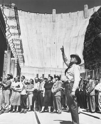 Increasing demands for water in the twentieth century led to some of the largest construction projects ever undertaken. The massive undertaking that created Hoover Dam captivated the public. Here a tour guide explains the dam's features to sightseeing visitors in 1949. Hoover Dam remains a popular tourist attraction.