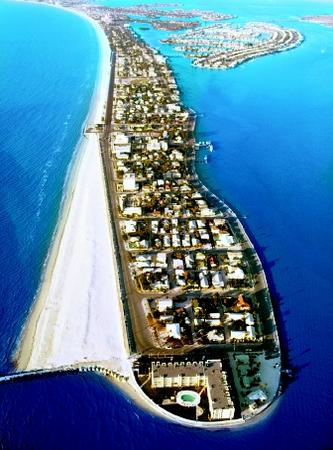 St. Petersburg Beach, Florida illustrates the heavy human development typically found on peninsulas. This photograph also shows an area of sand buildup (accretion) and removal (erosion) due to nearshore currents (see "Beaches" for an explanation).